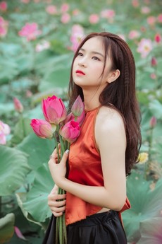 woman-looking-upward-while-holding-flowers-1322130.jpg