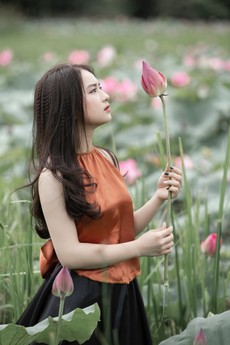 woman-in-brown-shirt-holding-pink-petaled-flower-1289399.jpg