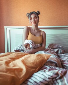 photo-of-smiling-woman-in-orange-spaghetti-strap-top-sitting-2908691.jpg