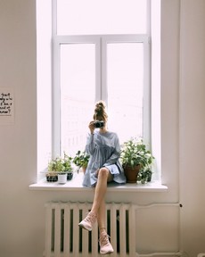 woman-in-grey-long-sleeved-dress-sitting-on-window-1109596.jpg