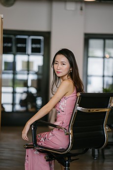 woman-in-pink-floral-cami-dress-sitting-on-black-chair-2337891.jpg