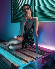 woman-sitting-on-wooden-pallet-with-her-fingers-on-her-chin-2587392.jpg