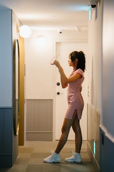 woman-standing-in-front-of-mirror-holding-sunglasses-1729091.jpg