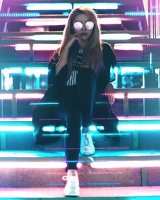 woman-wearing-black-and-sunglasses-sitting-near-led-lights-2752045.jpg