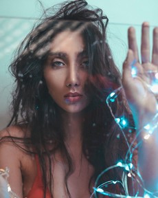 woman-wearing-red-bra-holding-blue-string-lights-2760249.jpg